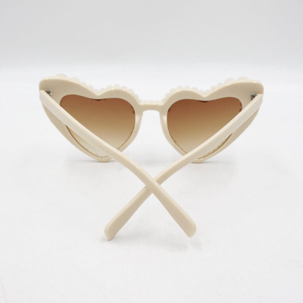 Large frame heart-shaped sunglasses with pearl embellishments, suitable for women to wear during vacations, at the beach, or at birthday parties.