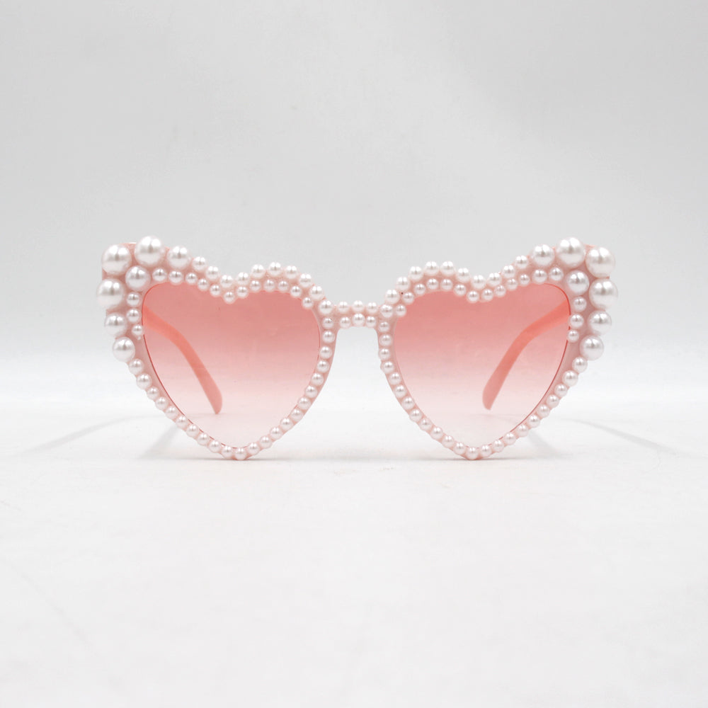Large frame heart-shaped sunglasses with pearl embellishments, suitable for women to wear during vacations, at the beach, or at birthday parties.