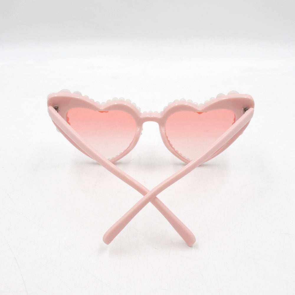 Large frame heart-shaped sunglasses with pearl embellishments, suitable for women to wear during vacations, at the beach, or at birthday parties.
