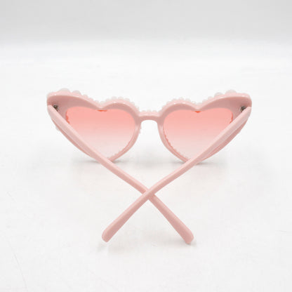 Large frame heart-shaped sunglasses with pearl embellishments, suitable for women to wear during vacations, at the beach, or at birthday parties.